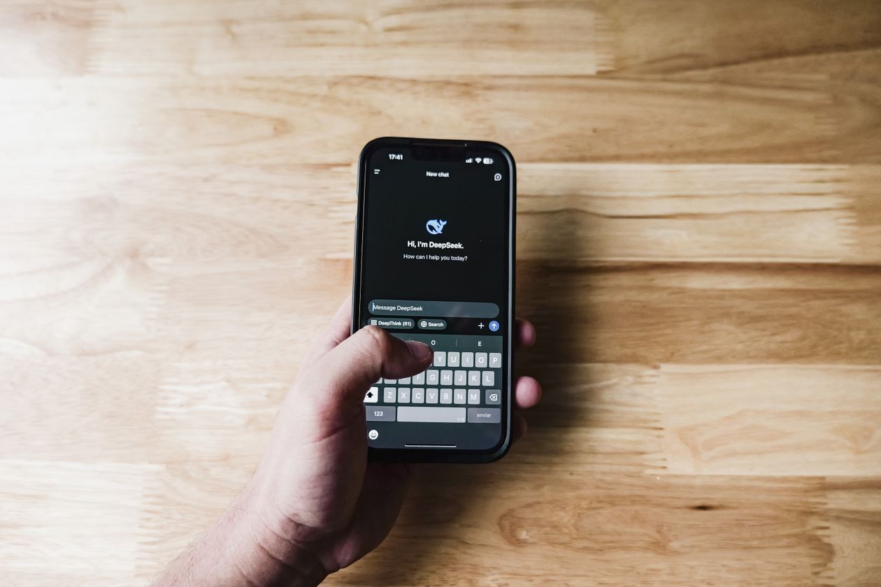Person using an AI chatbot assistant on a smartphone at home