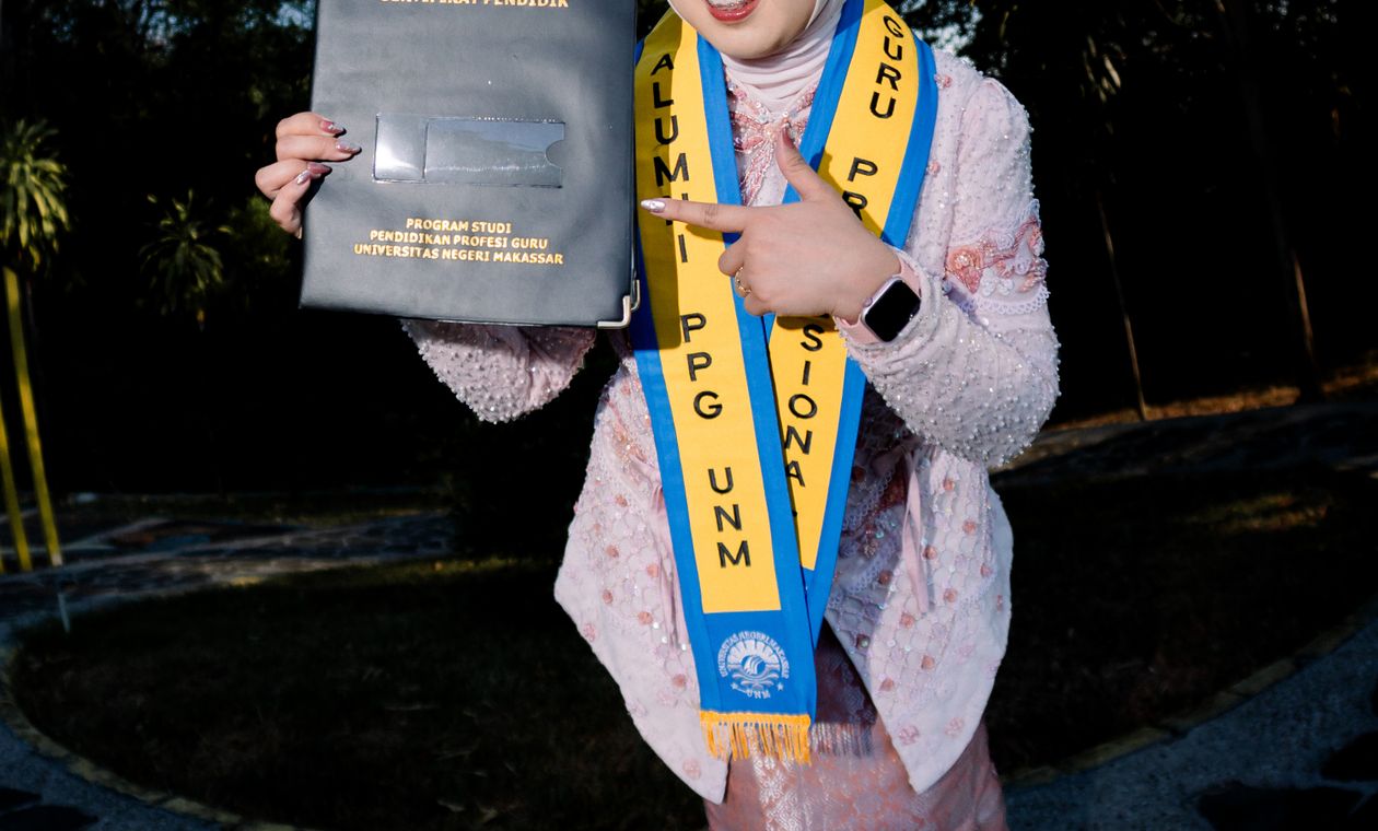 Young woman celebrating while holding her new certificate